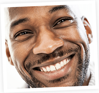 Smiling man displaying healthy teeth and confident dental health results.
