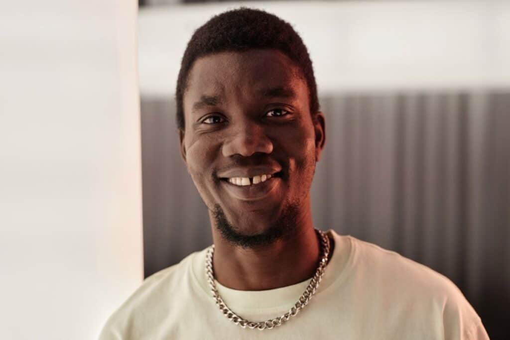 man smiling with gaps in between teeth