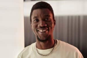 man smiling with gaps in between teeth