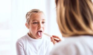 dentist checking tongue tie in child