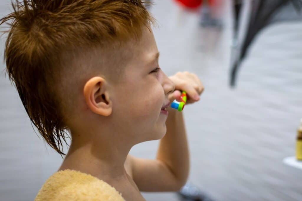 child brushing during summer