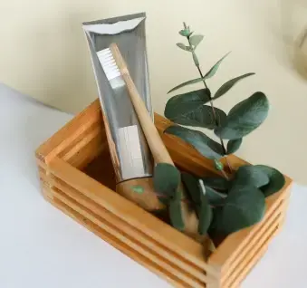 Wooden box with natural green eucalyptus and holistic dental care product.