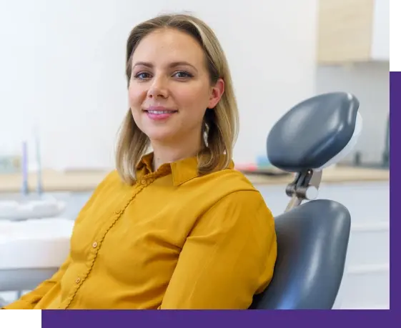 Female dental patient smiling in treatment chair at Ozone Dentistry in Niceville, Florida.