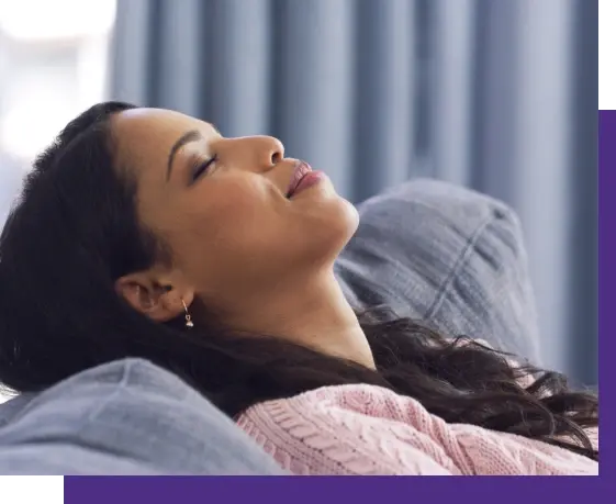 Woman relaxing on couch, illustrating comfort during sleep apnea treatment in Niceville, FL.
